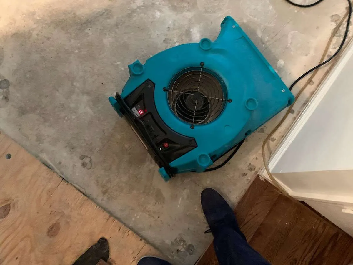 Air mover drying subfloor during Leak Detection & Repair in Monroe